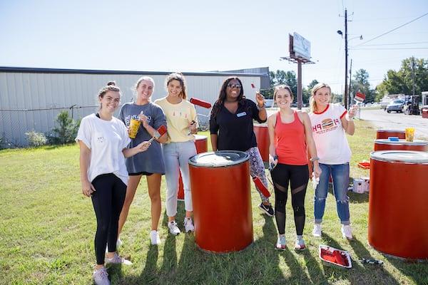 Students gathered around food drive collection barrells